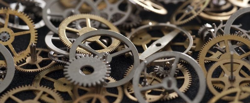 Selective Focus Close Up on Pile of Clock Parts, Assortment of Cogs and Gears in Variety of Sizes, Shapes and Metals
